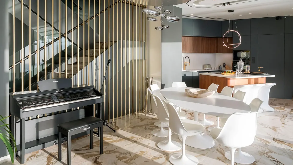 Grand piano and designer kitchen on marble floors