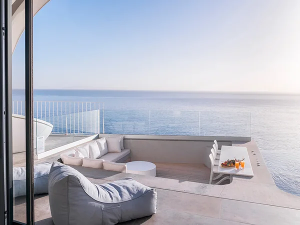 Outdoor lounge area with sea backdrop